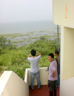 people watching lake from balcony